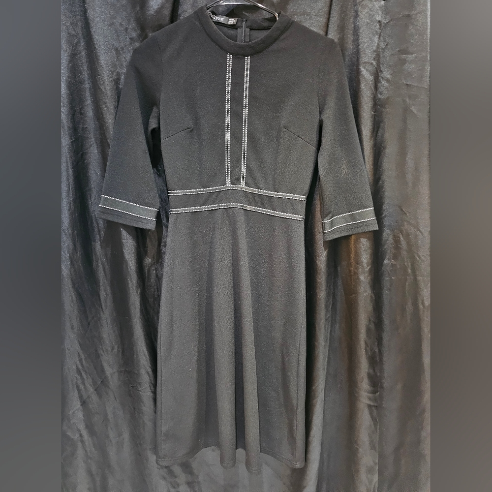 Knee-lenth black dress with white stitching detail